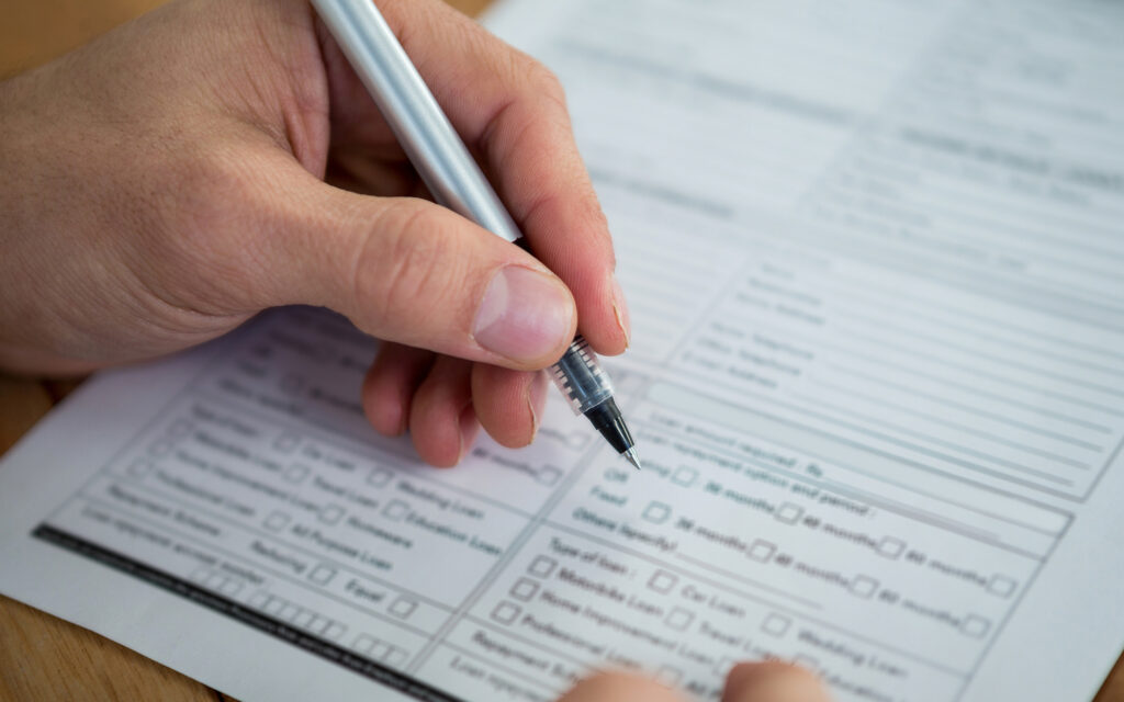 Businesswoman filling last will and testament form